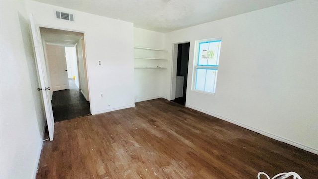 unfurnished bedroom featuring dark wood-type flooring