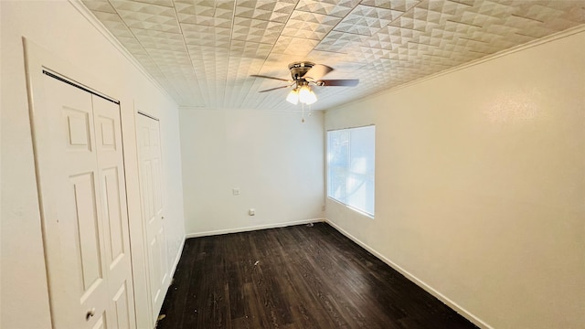 unfurnished bedroom featuring ceiling fan, crown molding, and dark hardwood / wood-style floors