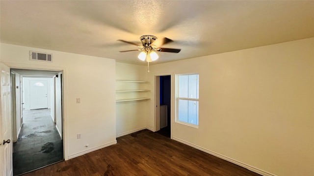 unfurnished bedroom featuring ceiling fan, dark hardwood / wood-style floors, and a closet