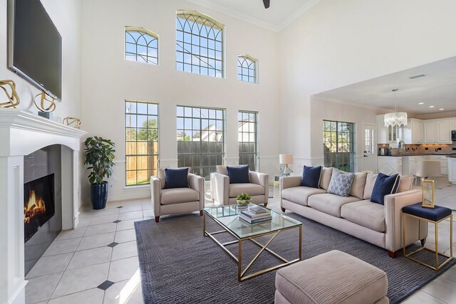 8215 Arrowhead Ln, Houston, TX 77075 - living area with ornamental molding, a lit fireplace, light tile patterned floors, a towering ceiling, and recessed lighting