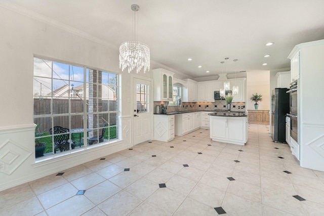 8215 Arrowhead Ln, Houston, TX 77075 - kitchen featuring dark countertops, stainless steel appliances, backsplash, ornamental molding, and white cabinets