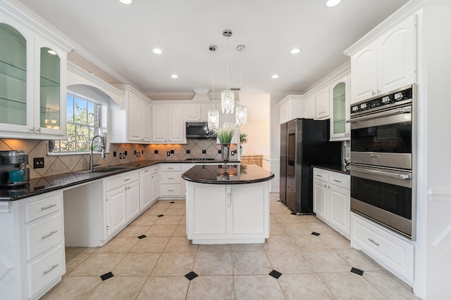 kitchen featuring pendant lighting, a center island, backsplash, sink, and stainless steel appliances