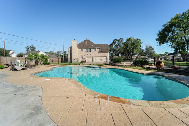 view of pool with a patio area and an in ground hot tub