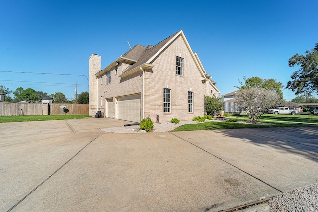 8215 Arrowhead Ln, Houston, TX 77075 - view of property exterior with an attached garage, brick siding, concrete driveway, and a chimney
