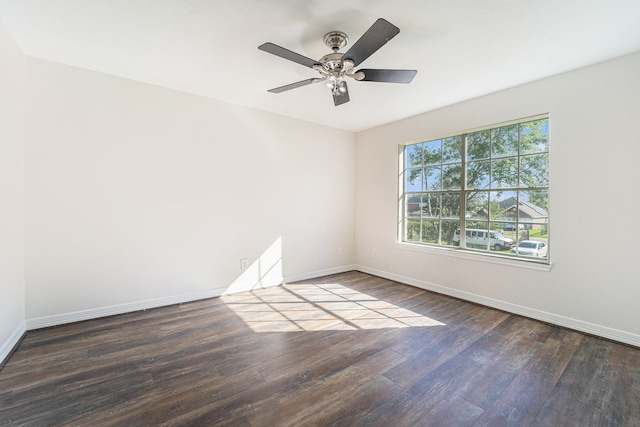 unfurnished room featuring ceiling fan and dark wood-type flooring