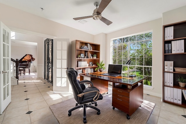 tiled office featuring french doors and ceiling fan