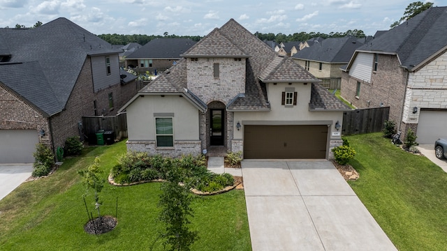 view of front of home with a front lawn and a garage