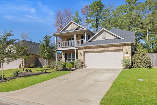 view of front facade featuring a front yard, a balcony, and a garage