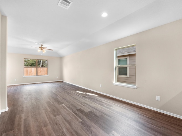 empty room featuring lofted ceiling, ceiling fan, and dark hardwood / wood-style floors