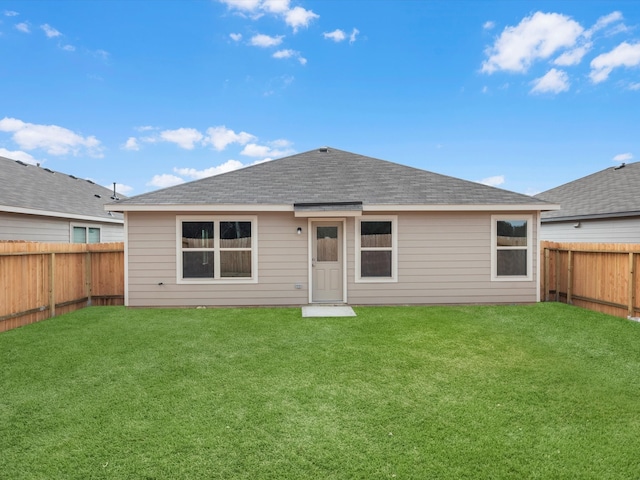 rear view of house featuring a yard