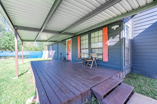 deck with a lawn and a trampoline