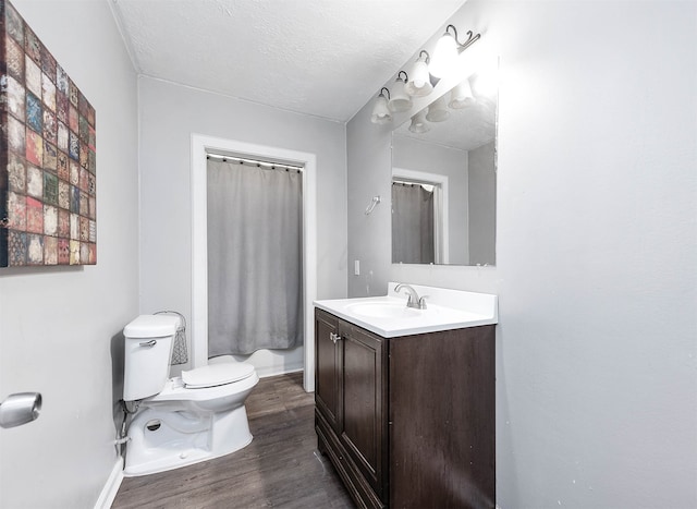 bathroom with vanity, hardwood / wood-style floors, a textured ceiling, and toilet