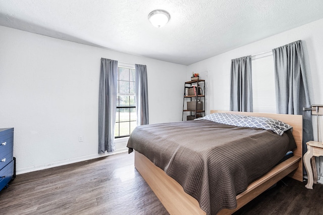 bedroom featuring wood-type flooring and a textured ceiling