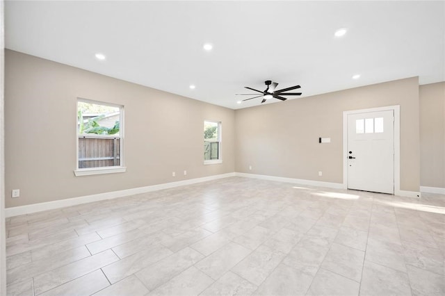 unfurnished living room with plenty of natural light and ceiling fan