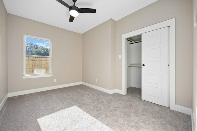 unfurnished bedroom with light carpet, a closet, and ceiling fan