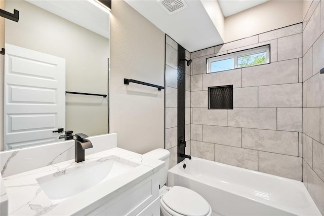 full bathroom with vanity, toilet, and tiled shower / bath