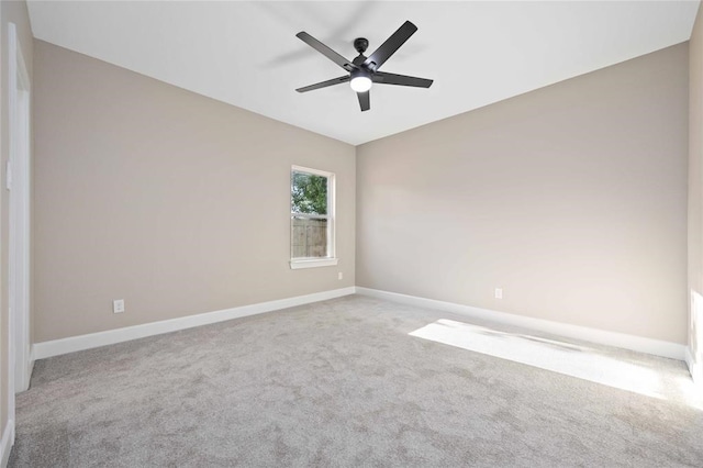 spare room with ceiling fan and light colored carpet