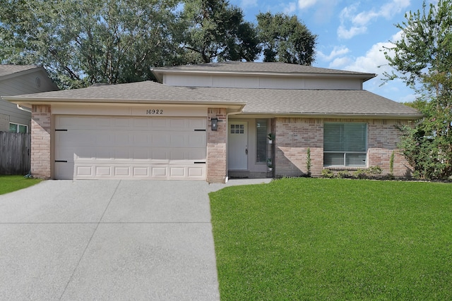 view of front facade with a garage and a front lawn