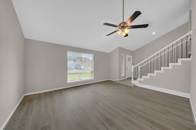 unfurnished living room with hardwood / wood-style flooring, ceiling fan, and lofted ceiling