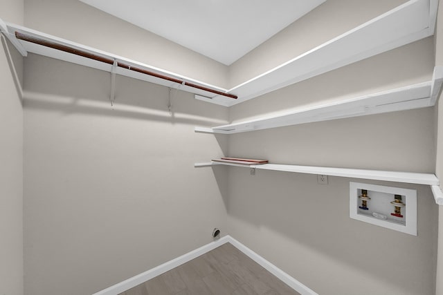 laundry area with electric dryer hookup, hookup for a washing machine, and hardwood / wood-style flooring