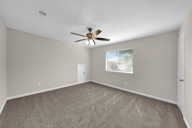 empty room with carpet floors, a textured ceiling, and ceiling fan