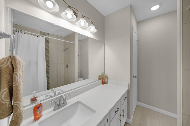 bathroom featuring tile patterned flooring, vanity, curtained shower, and toilet