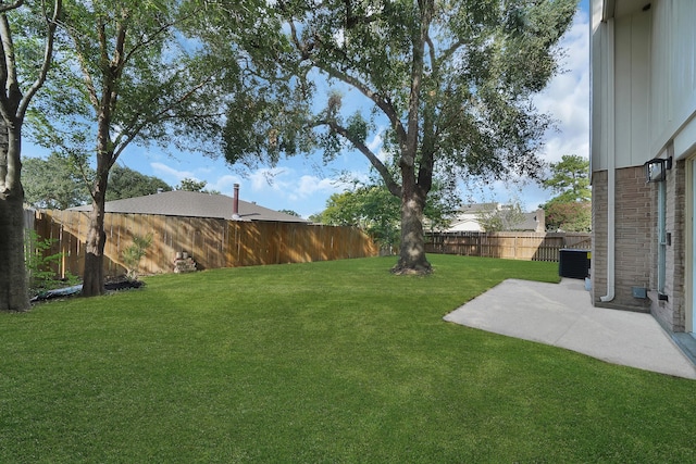 view of yard with central AC and a patio area