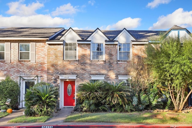 townhome / multi-family property featuring brick siding