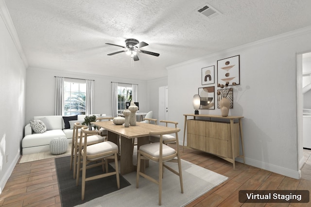 dining space with a textured ceiling, light hardwood / wood-style floors, ceiling fan, and ornamental molding