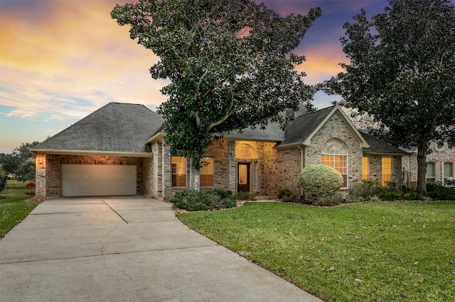 view of front of home with a lawn and a garage