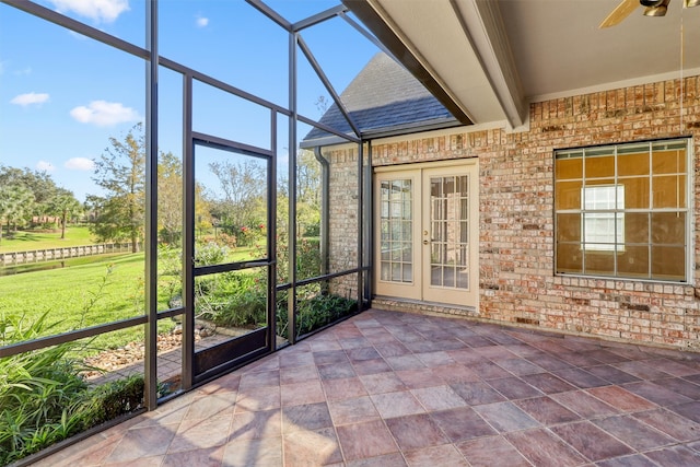 unfurnished sunroom with beamed ceiling, french doors, and ceiling fan