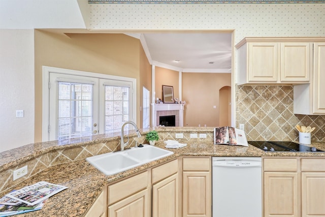 kitchen with dishwasher, black electric stovetop, sink, ornamental molding, and a tiled fireplace