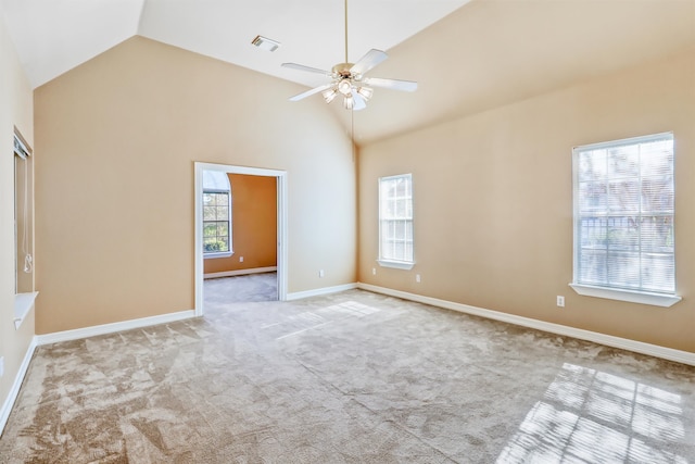 carpeted spare room featuring ceiling fan and high vaulted ceiling