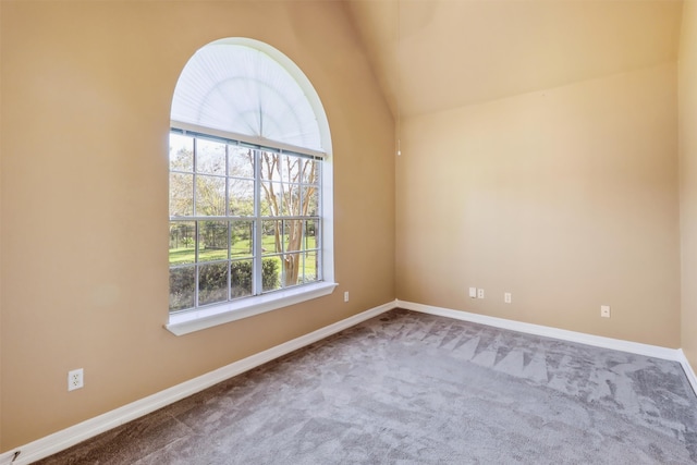 unfurnished room featuring carpet flooring and lofted ceiling