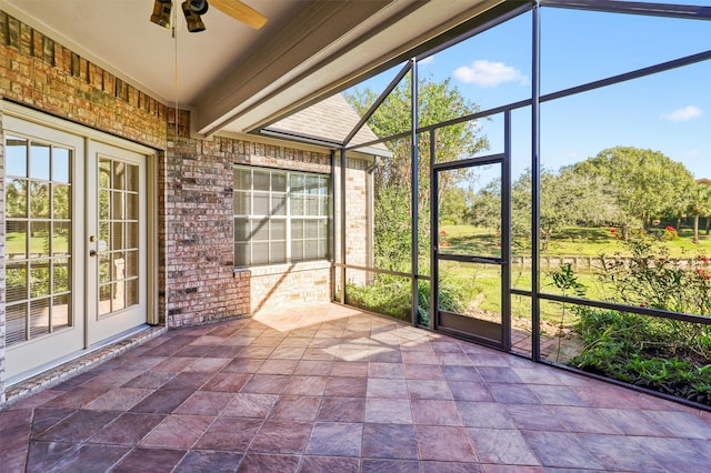 unfurnished sunroom featuring plenty of natural light and ceiling fan