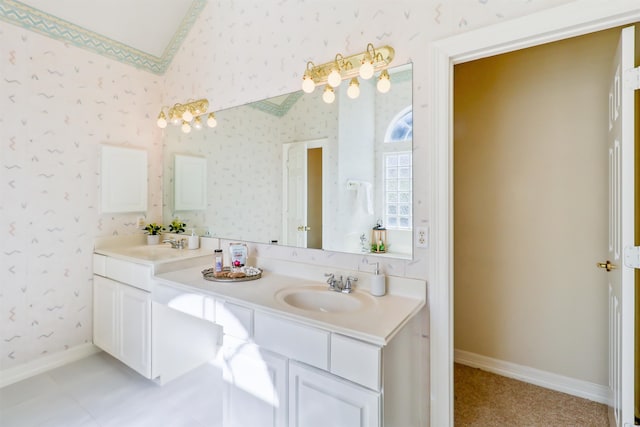 bathroom with vanity and lofted ceiling