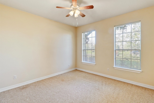 empty room with ceiling fan and light colored carpet