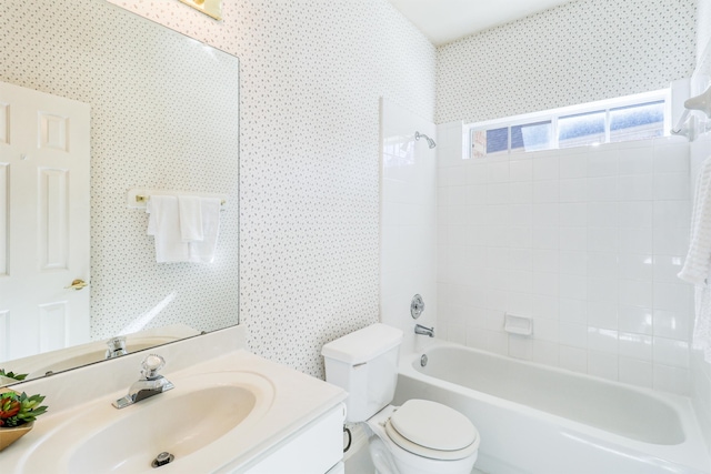 full bathroom with vanity, toilet, and tiled shower / bath