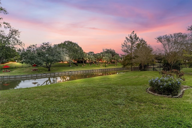 yard at dusk with a water view