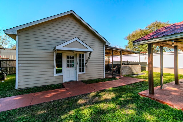 view of front of house with a front lawn and a patio