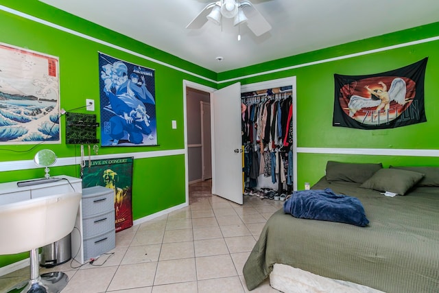 bedroom with ceiling fan, a closet, and light tile patterned flooring