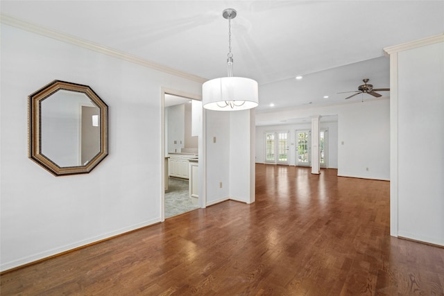 interior space featuring ceiling fan, dark wood-type flooring, and crown molding