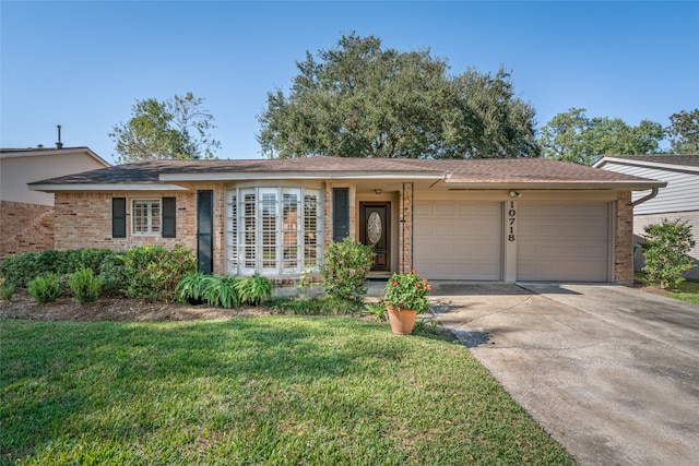 ranch-style house with a front yard and a garage