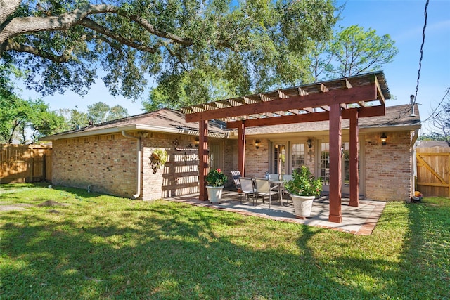 rear view of property with a pergola, a yard, and a patio