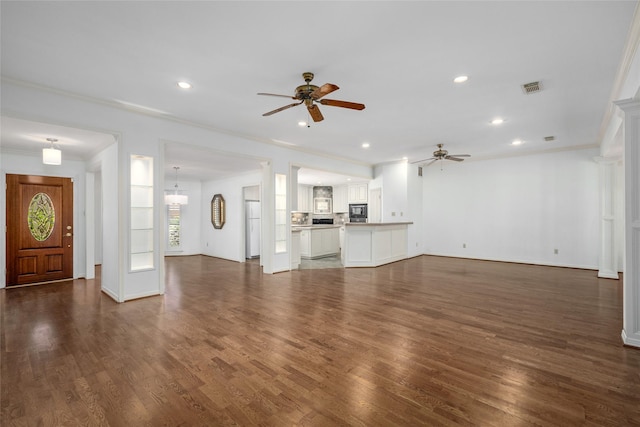 unfurnished living room featuring ceiling fan, ornamental molding, and dark hardwood / wood-style floors