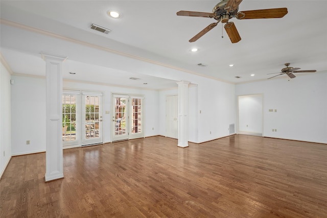 empty room with ceiling fan, dark wood-type flooring, crown molding, and decorative columns