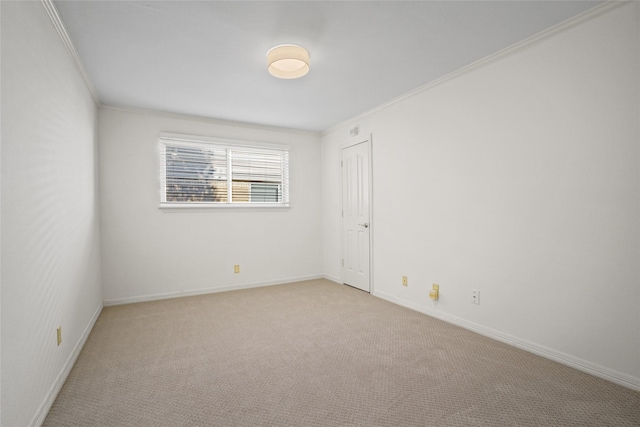 spare room with light carpet and ornamental molding