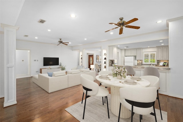 dining room with ceiling fan, ornamental molding, and hardwood / wood-style floors