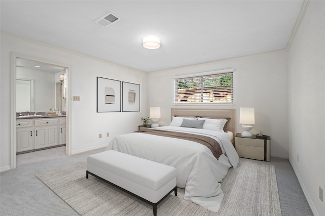 bedroom with ensuite bathroom, crown molding, light colored carpet, and sink