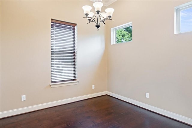 1516 Amundsen St, Houston, TX 77009 - empty room featuring a chandelier, dark wood-type flooring, and crown molding